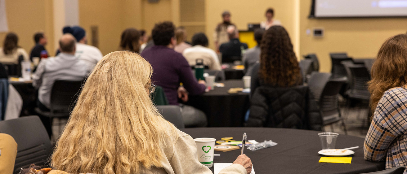 student success member sitting at table during conference